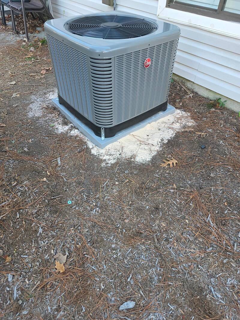 New Rheem AC condenser installed on a pad by All Star Heating & Air