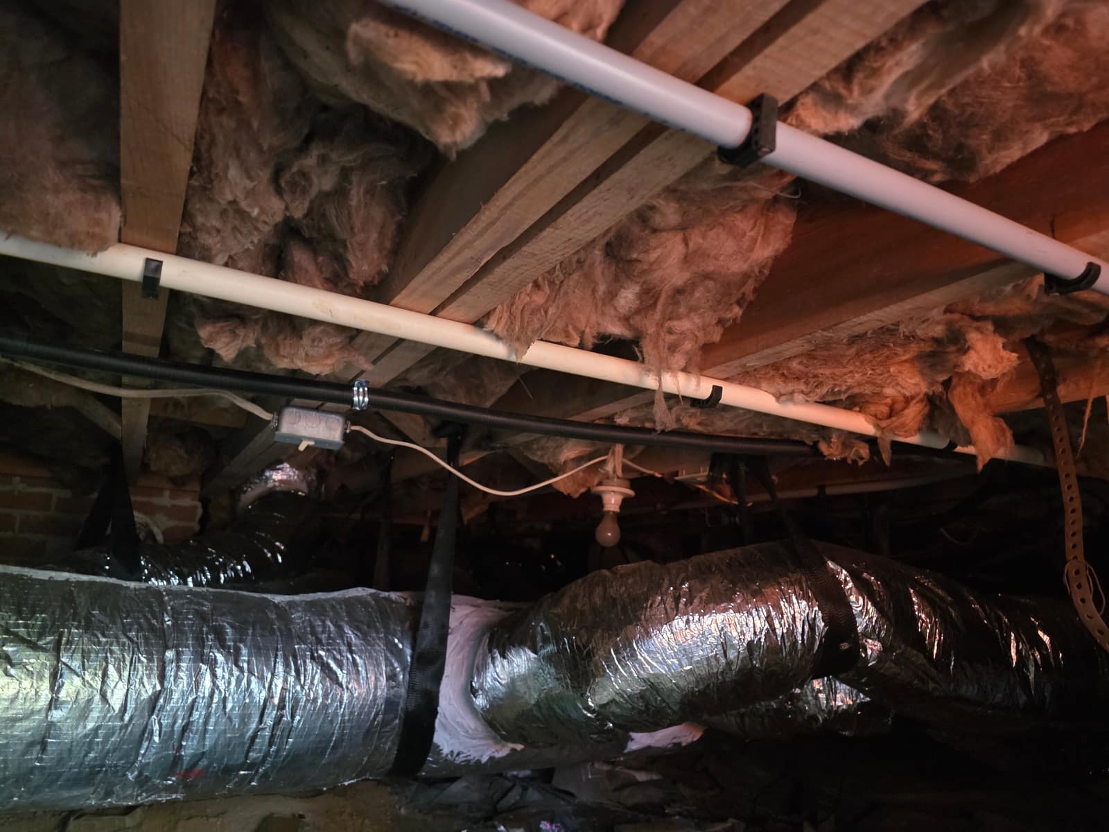 Freshly insulated ductwork running through a Lowcountry crawl space